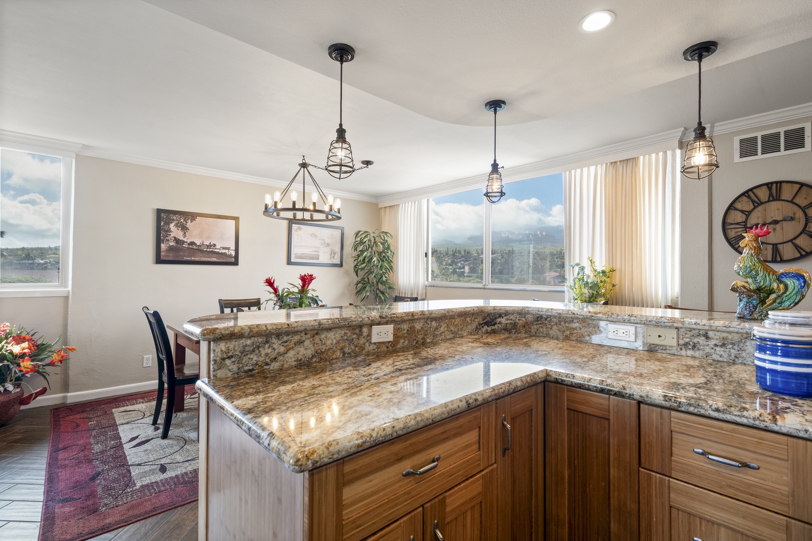 Your open-concept kitchen flows seamlessly into a bright dining area, with granite counters and pendant lighting adding warmth and character to the space.