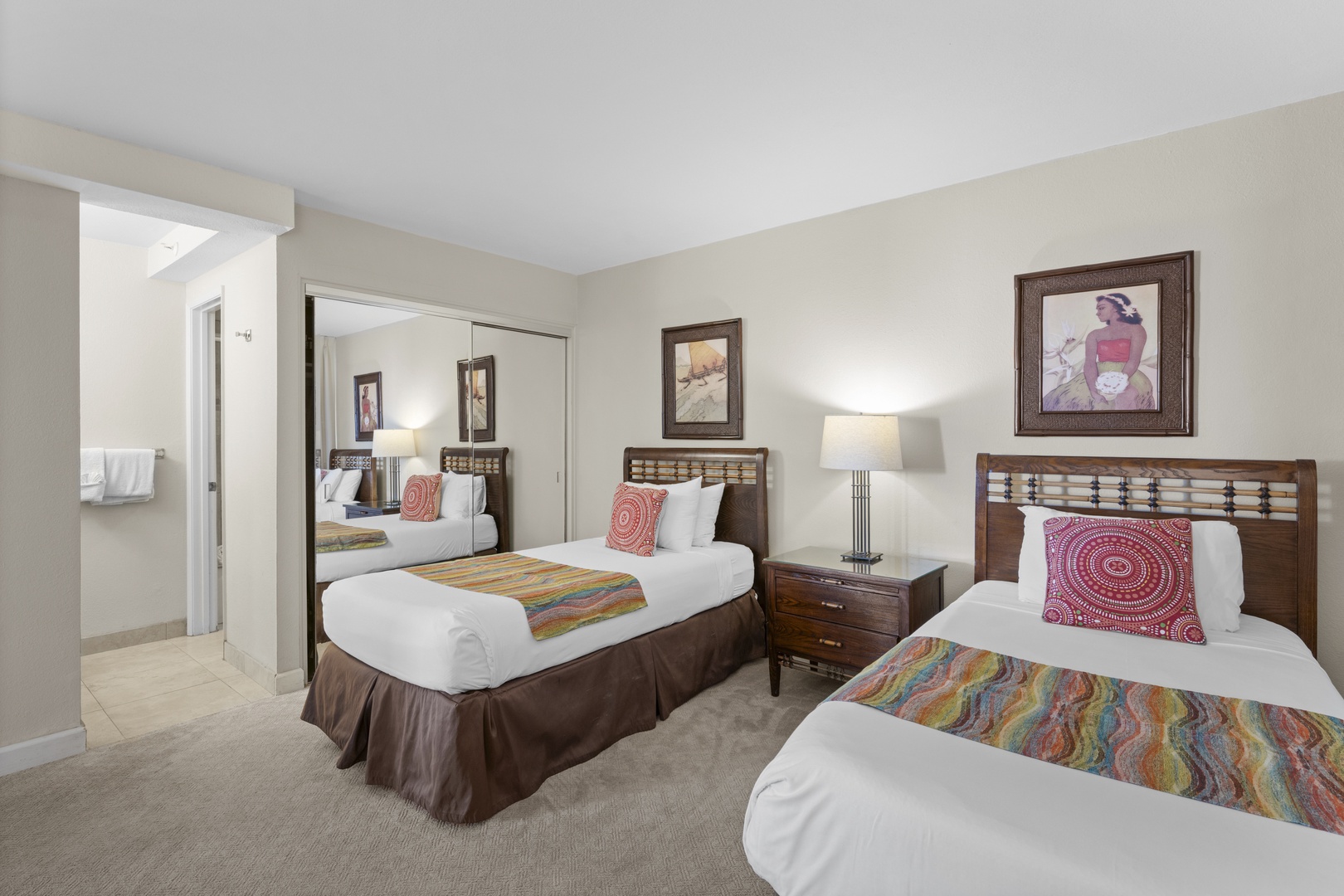 Rest peacefully in your twin bedroom featuring comfortable beds with vibrant accent pillows and warm lighting for ultimate relaxation.