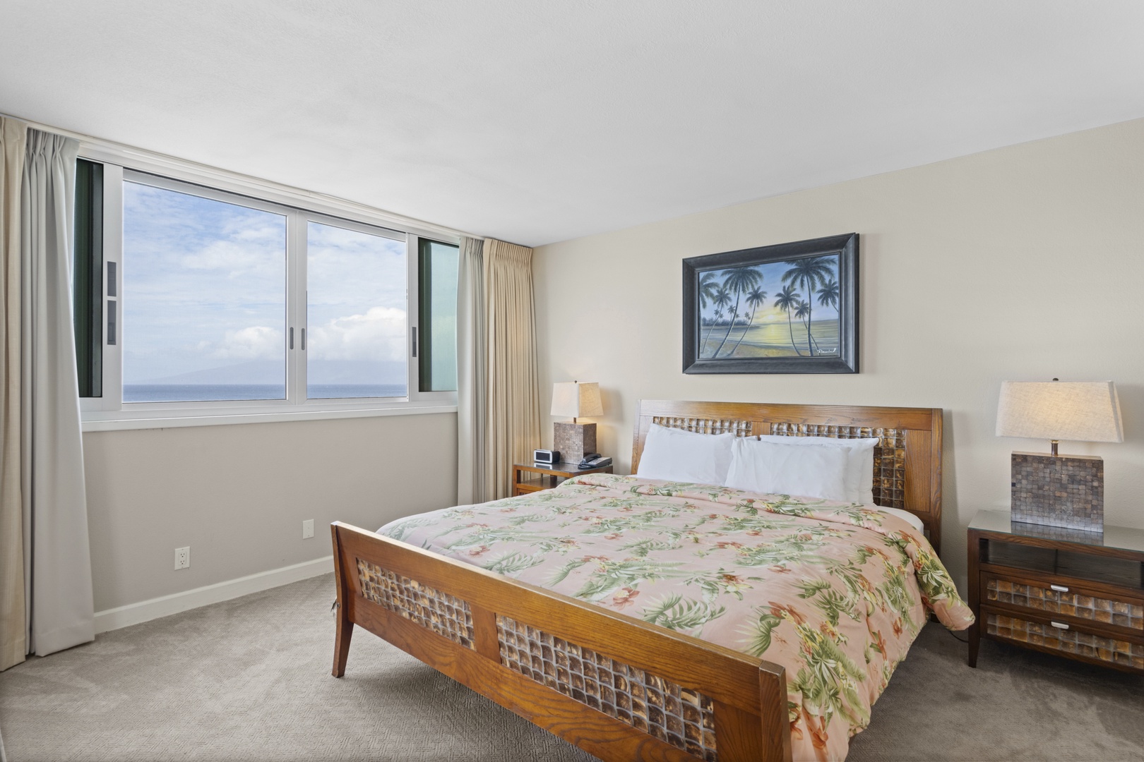 Wake up to stunning ocean views from your comfortable bedroom, where tropical decor and soft linens create the perfect island retreat.