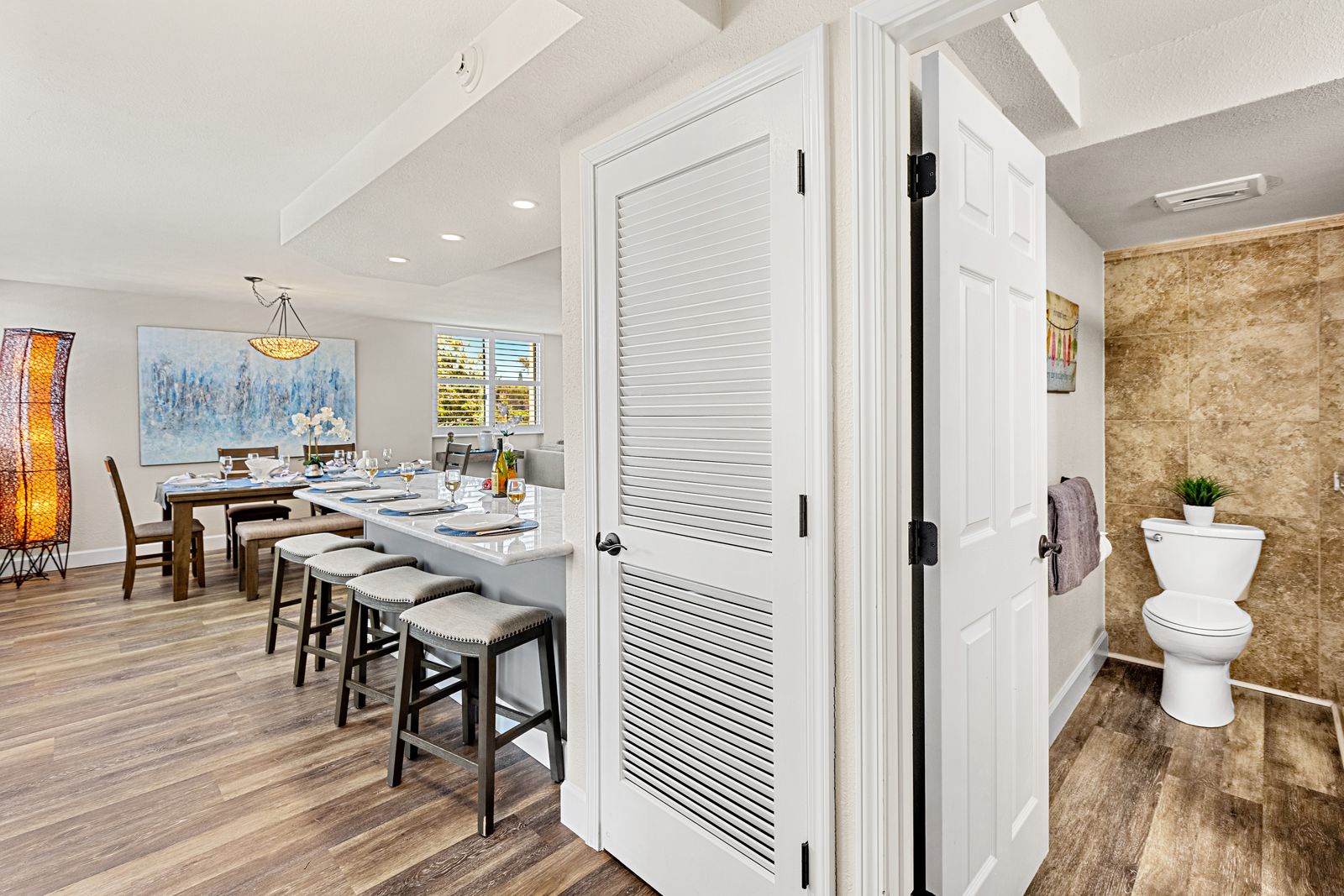 Your stylish dining space flows seamlessly into a luxurious bathroom, offering comfort and convenience in one beautifully designed area.