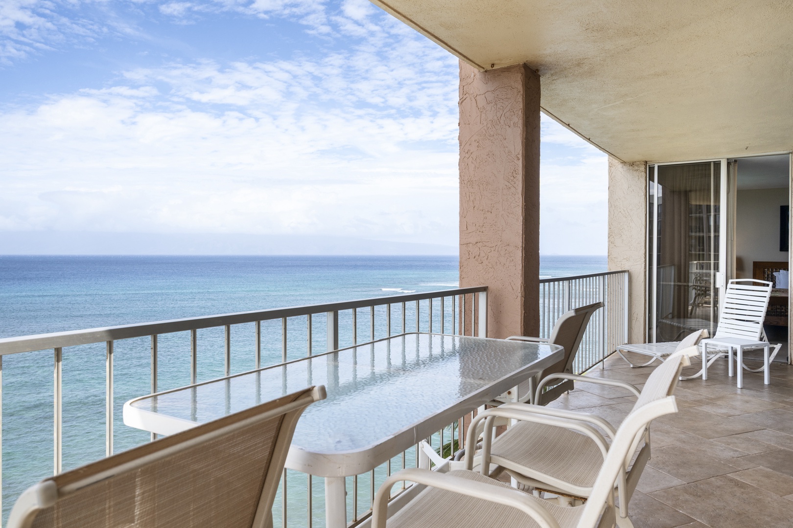 Your private oceanfront balcony awaits with comfortable seating and stunning sea views for morning coffee or sunset relaxation.