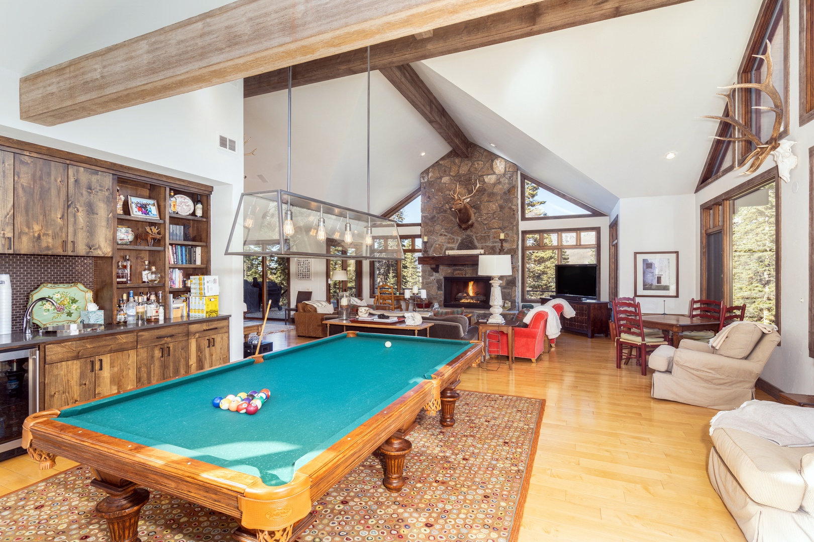 Open concept living room with pool table and bar