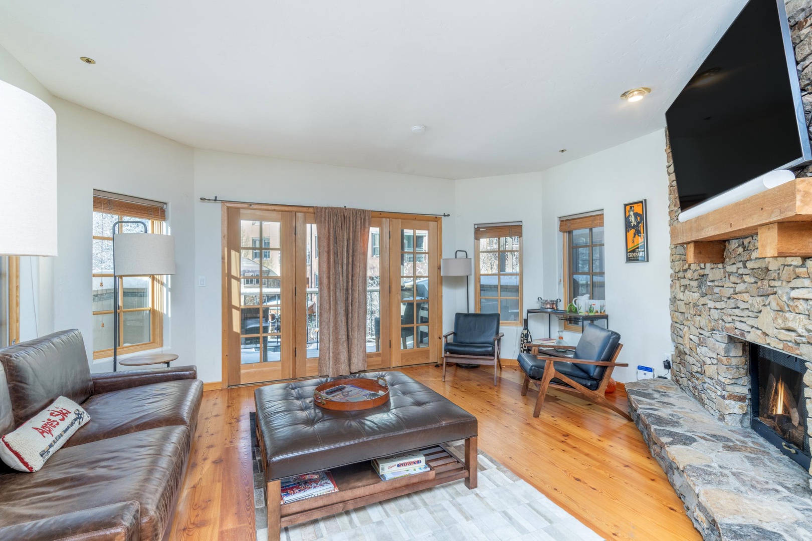 Spacious living room with private deck and fireplace