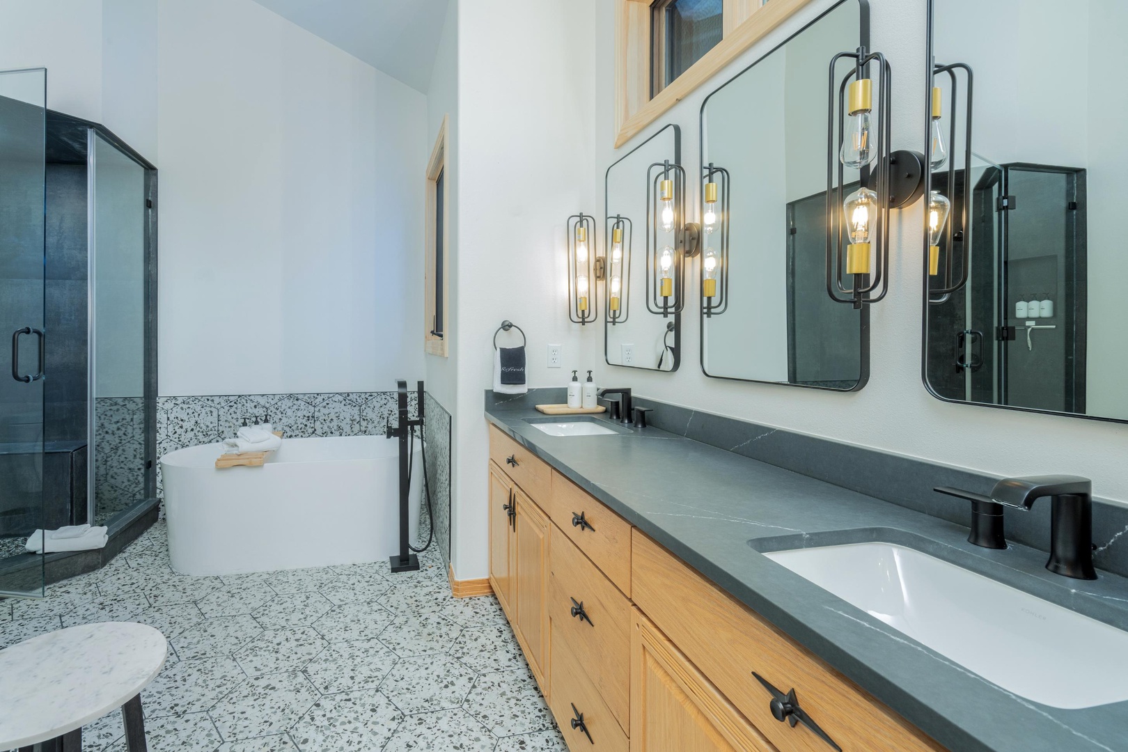 Unwind in your stylish bathroom with dual vanities, elegant lighting, and a luxurious soaking tub perfect for relaxing after a day of adventures.