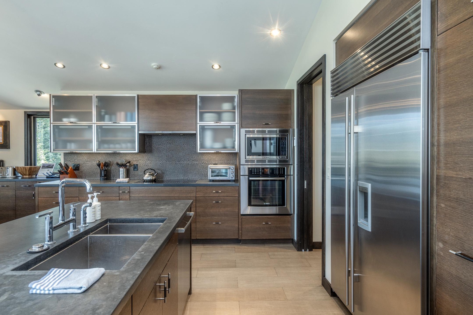 Kitchen looks out to the living room and dining