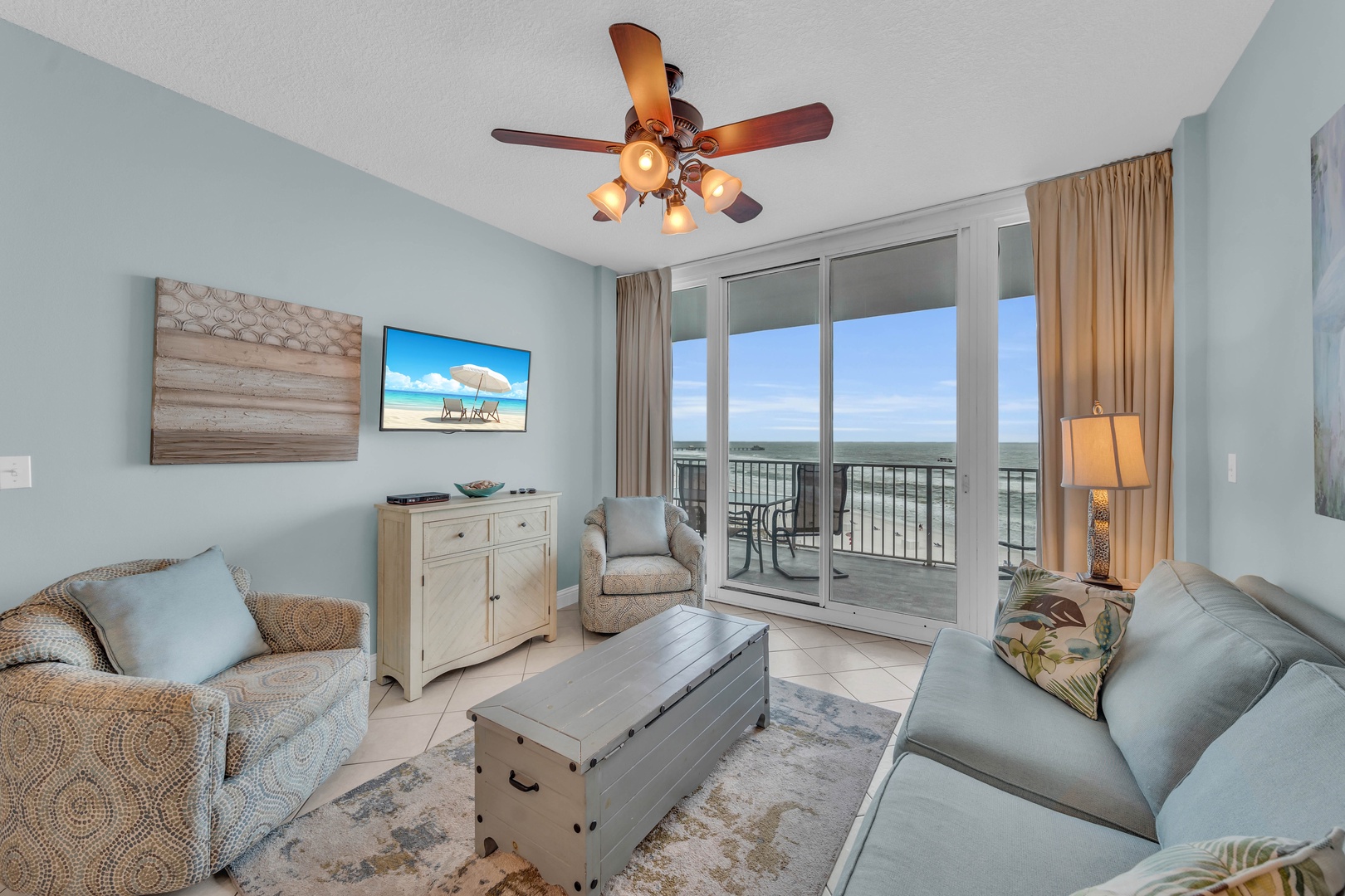 The Living Room seamlessly opens onto the expansive balcony, offering a panoramic view of the Beautiful Blue-Green waters of the Gulf of Mexico and the White Sugar Beaches of Gulf Shores.