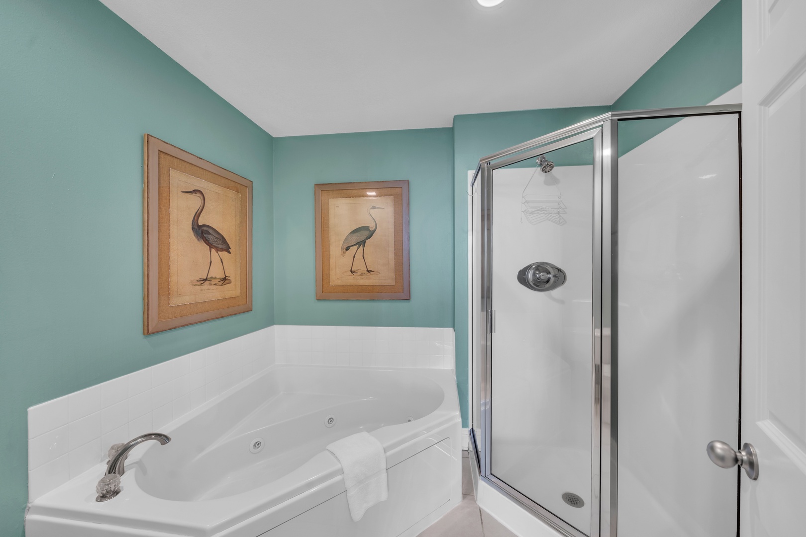 The Primary Bedroom has a jetted soaking tub, and a separate glass-enclosed shower.