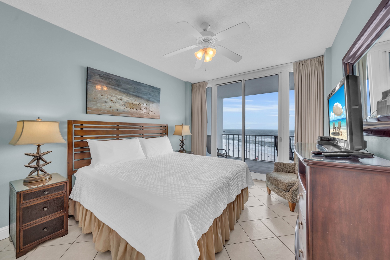 The Primary Bedroom, with its sliding floor-to-ceiling doors opening onto the spacious Gulf Front Balcony.