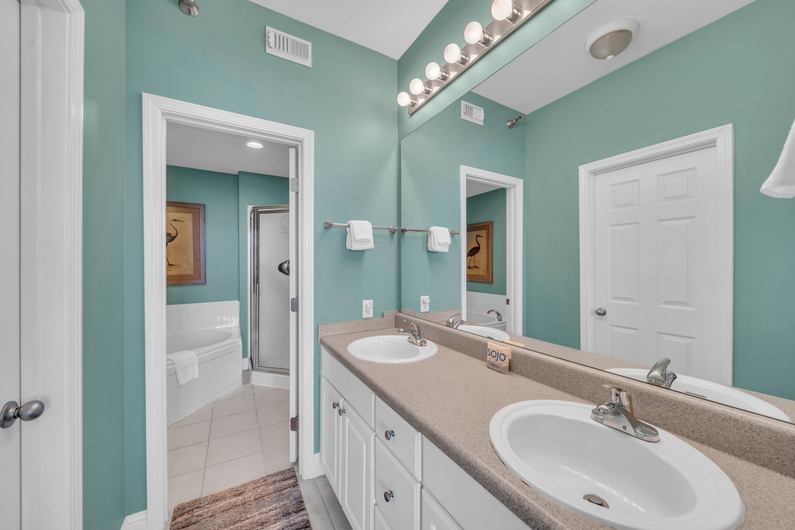 The Primary Bedroom boasts a large walk-in closet, a private dressing area with two sinks.