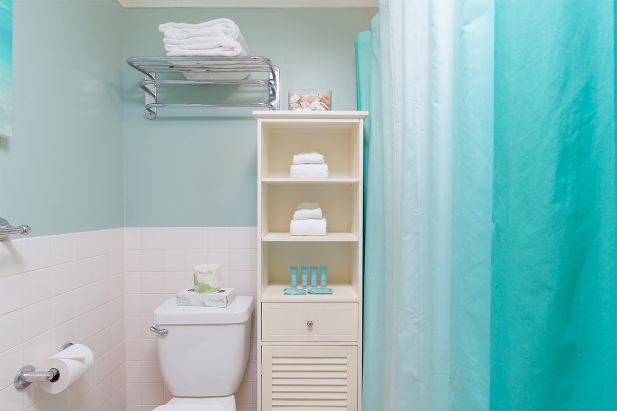 Your bathroom features fresh towels and complimentary toiletries thoughtfully arranged for your arrival, with calming coastal colors creating a spa-like retreat.