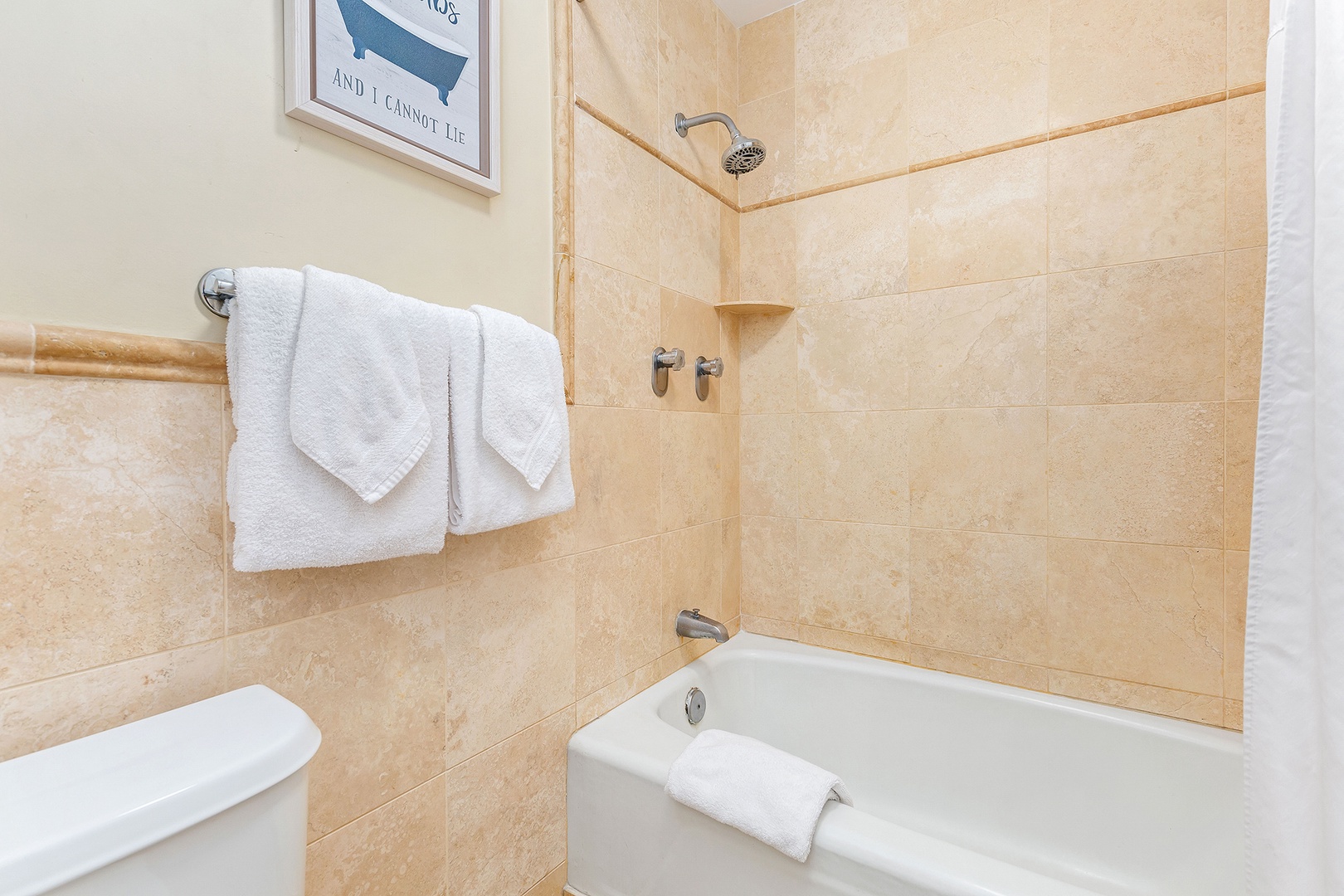 Unwind in your private spa-like bathroom with a deep soaking tub, rainfall showerhead, and plush towels waiting to wrap you in comfort after a long day of exploring.