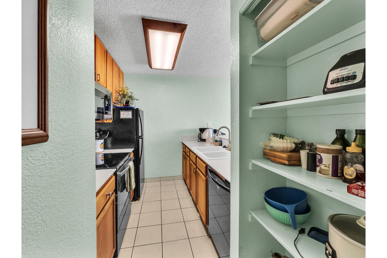 Your fully equipped kitchen features modern appliances and organized pantry shelving for all your culinary needs during your stay.