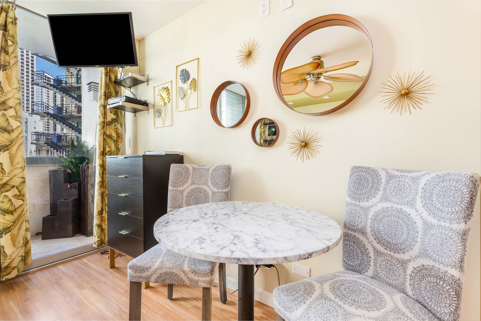 Gather around your private marble-topped table with stylish seating and modern décor. Enjoy meals in comfort with a smart TV, ceiling fan, and a welcoming balcony view just steps away.