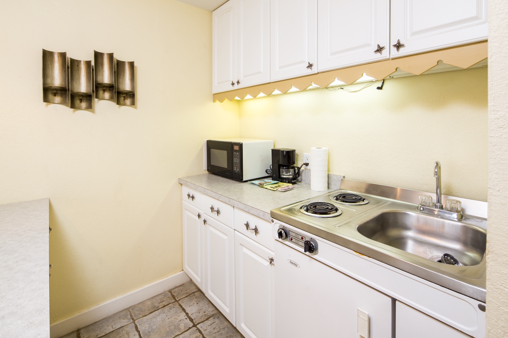Your kitchenette has everything you need: microwave, coffee maker, stove, and sink—ready to make quick meals or brew fresh coffee before starting your day.