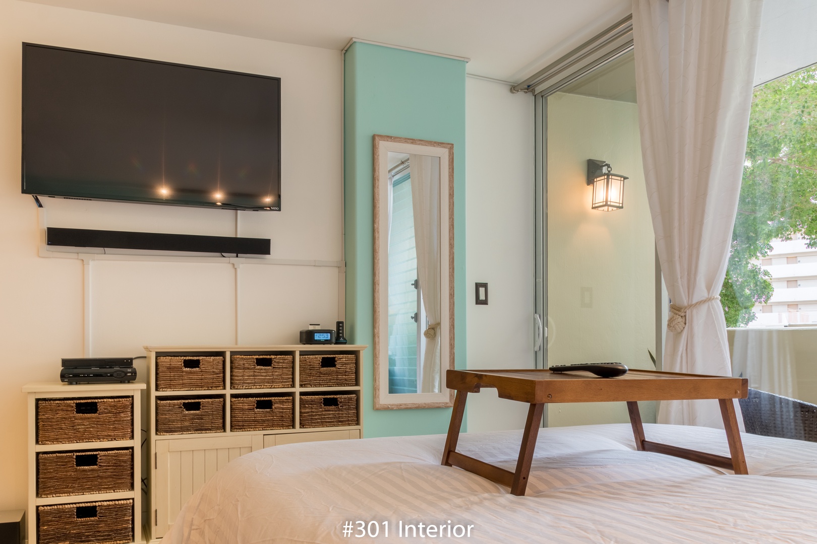 Unwind in this soothing space with your own flat-screen TV, organized storage baskets, and a sliding door that opens to fresh air and greenery just outside.