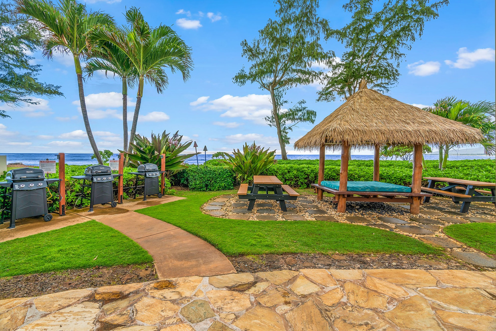 Your private oceanfront paradise features BBQ grills and tropical cabana seating just steps from the beach.