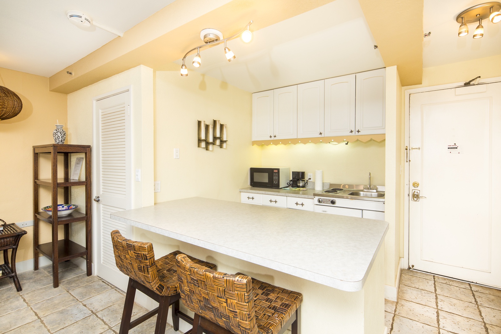 Your bright, fully-equipped kitchen features warm tones, modern appliances, and a spacious breakfast bar perfect for casual meals or morning coffee together.
