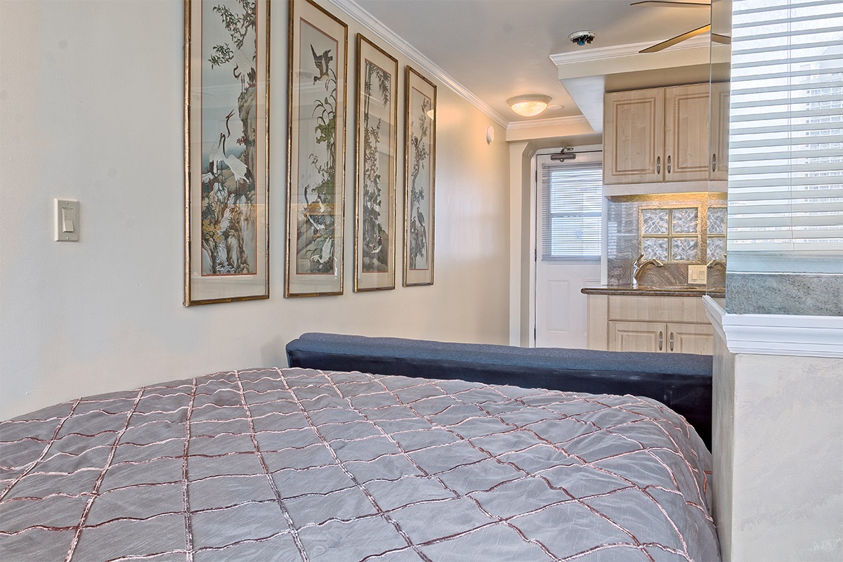 Slip into a cozy bed adorned with elegant artwork and enjoy the convenience of your own fully-equipped kitchenette just steps away, creating a perfect home base for your getaway.