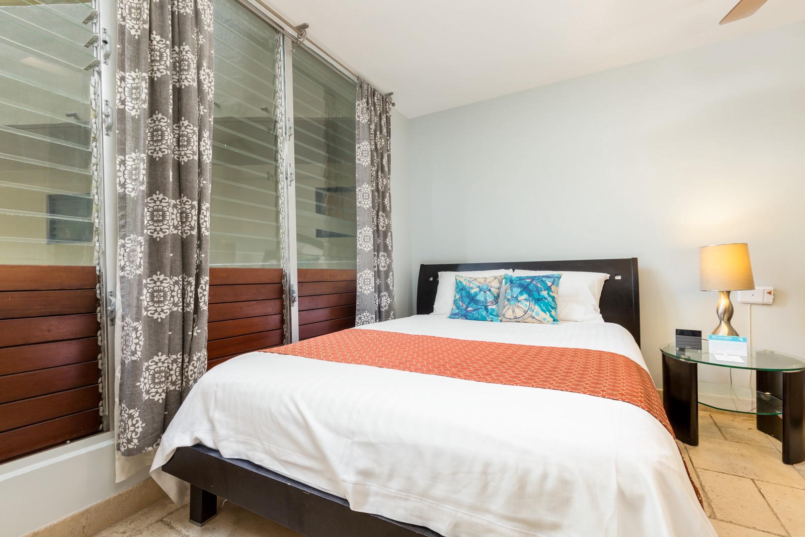 Slip into crisp, inviting linens and unwind in your bright, peaceful bedroom. Vibrant accent pillows add a pop of color, while warm lighting creates the perfect mood for rest.