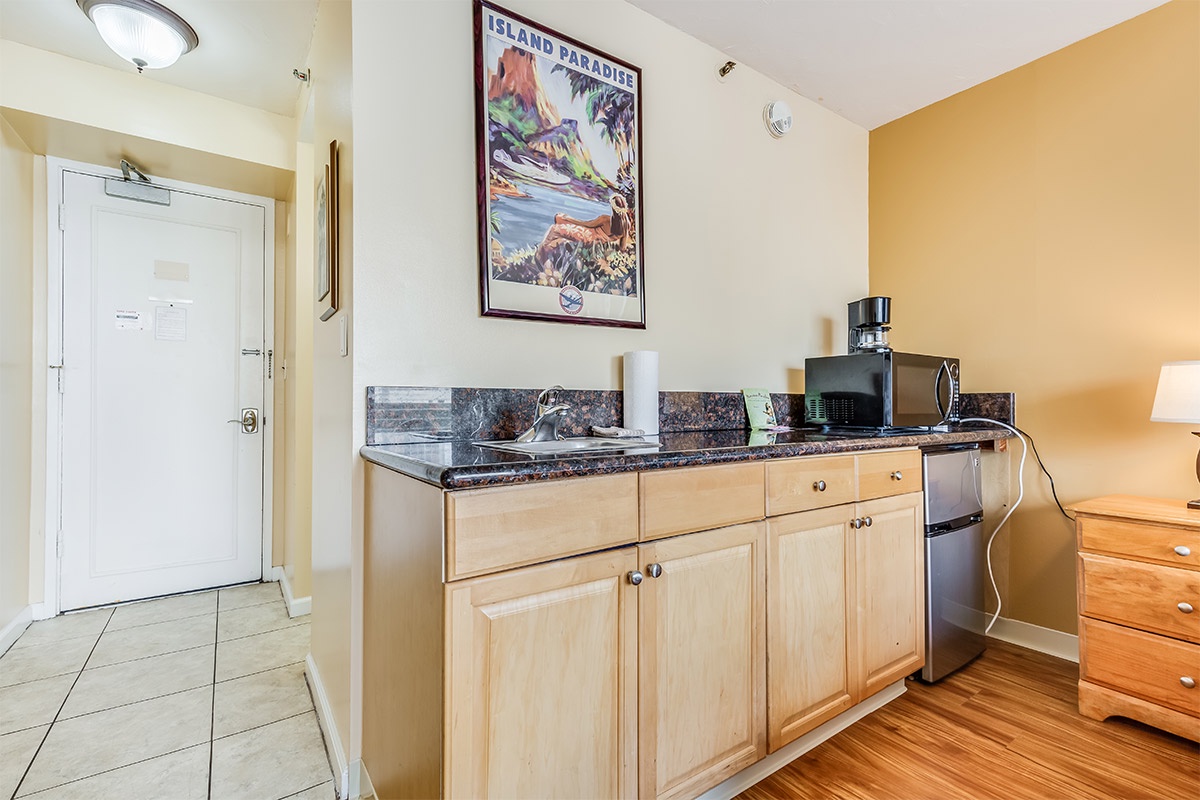 Your cozy kitchenette awaits, complete with a microwave, coffee maker, and mini-fridge—perfect for quick meals or morning coffee before exploring the island paradise just outside your door.