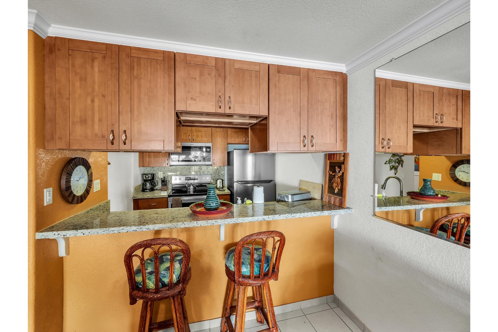 Cook your favorite meals in this bright kitchen featuring warm wood cabinetry, granite countertops, and stainless steel appliances.