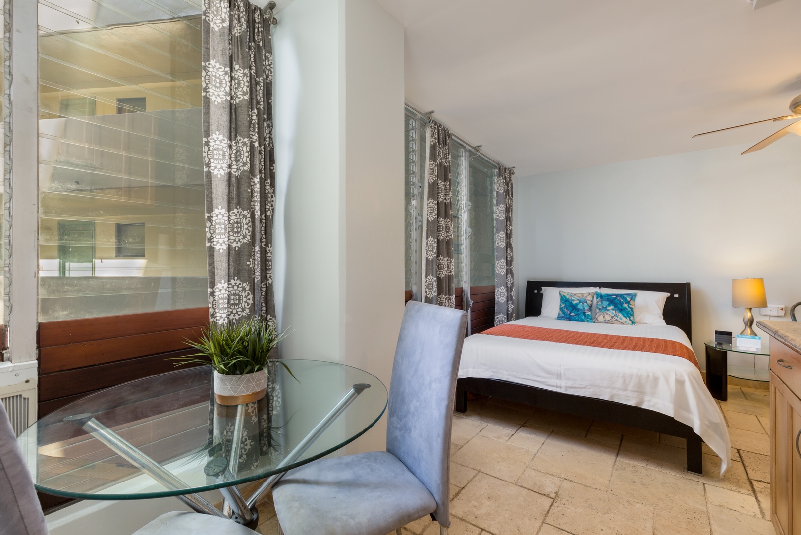 Unwind in your bright, open bedroom featuring modern furnishings, a cozy bed, and a stylish seating area where you can relax after exploring the city.