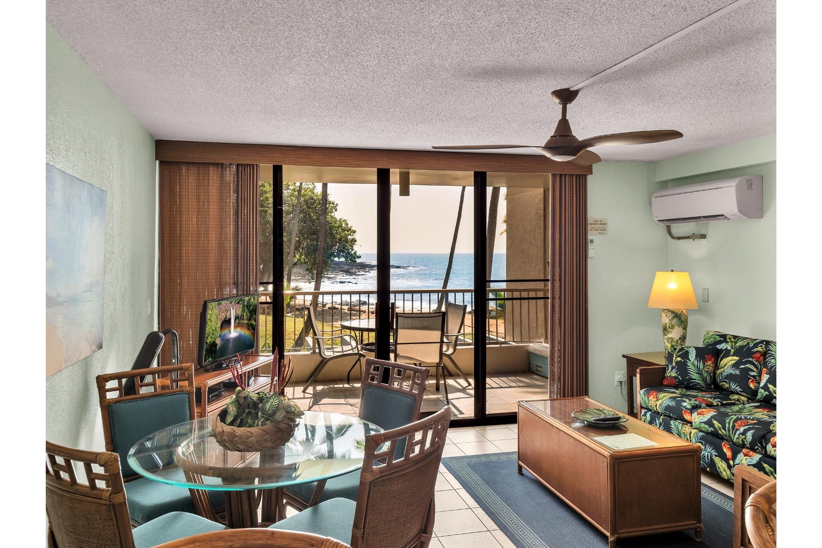 Relax in your tropical living space with ocean views from your private balcony, complete with dining area and comfortable seating.