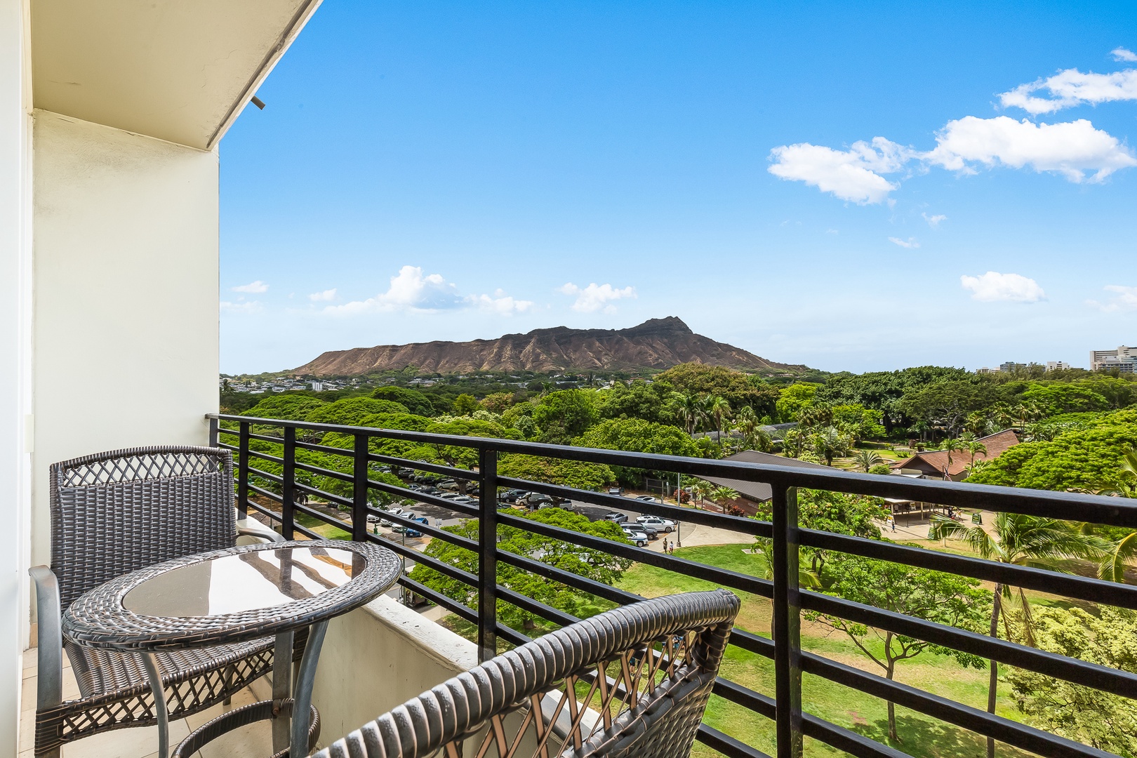 Sweeping views of Diamond Head and lush tropical foliage frame this private balcony. Enjoy morning coffee or evening relaxation with Hawaii's iconic volcanic peak as your backdrop.