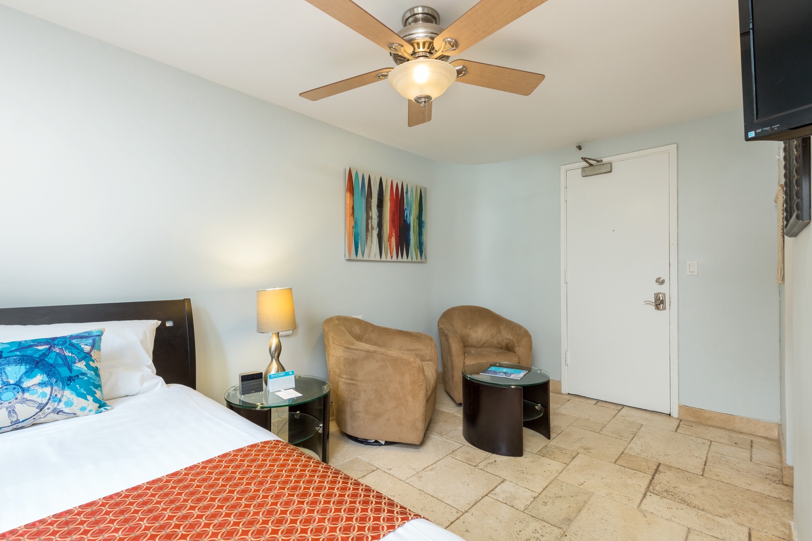 Settle into your bright, comfortable retreat with a plush bed, cozy seating, and thoughtful touches—all bathed in natural light and kept cool by your private ceiling fan.