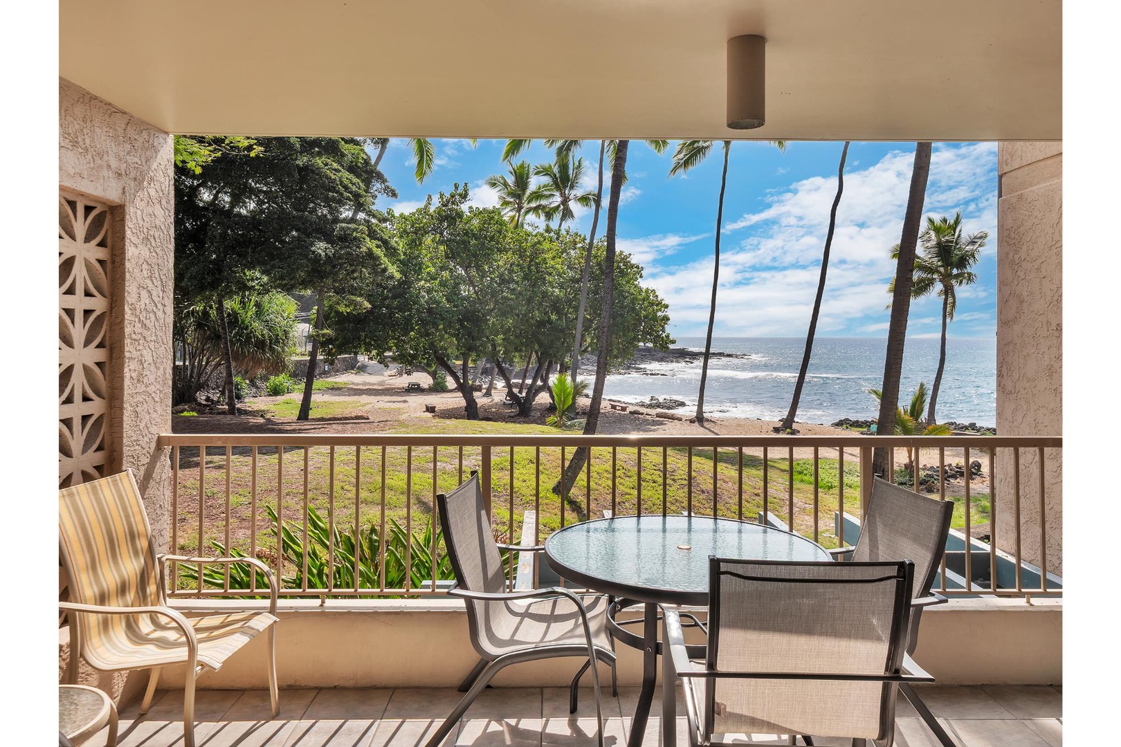 Enjoy morning coffee on your private balcony while watching waves lap the tropical shoreline just steps away.