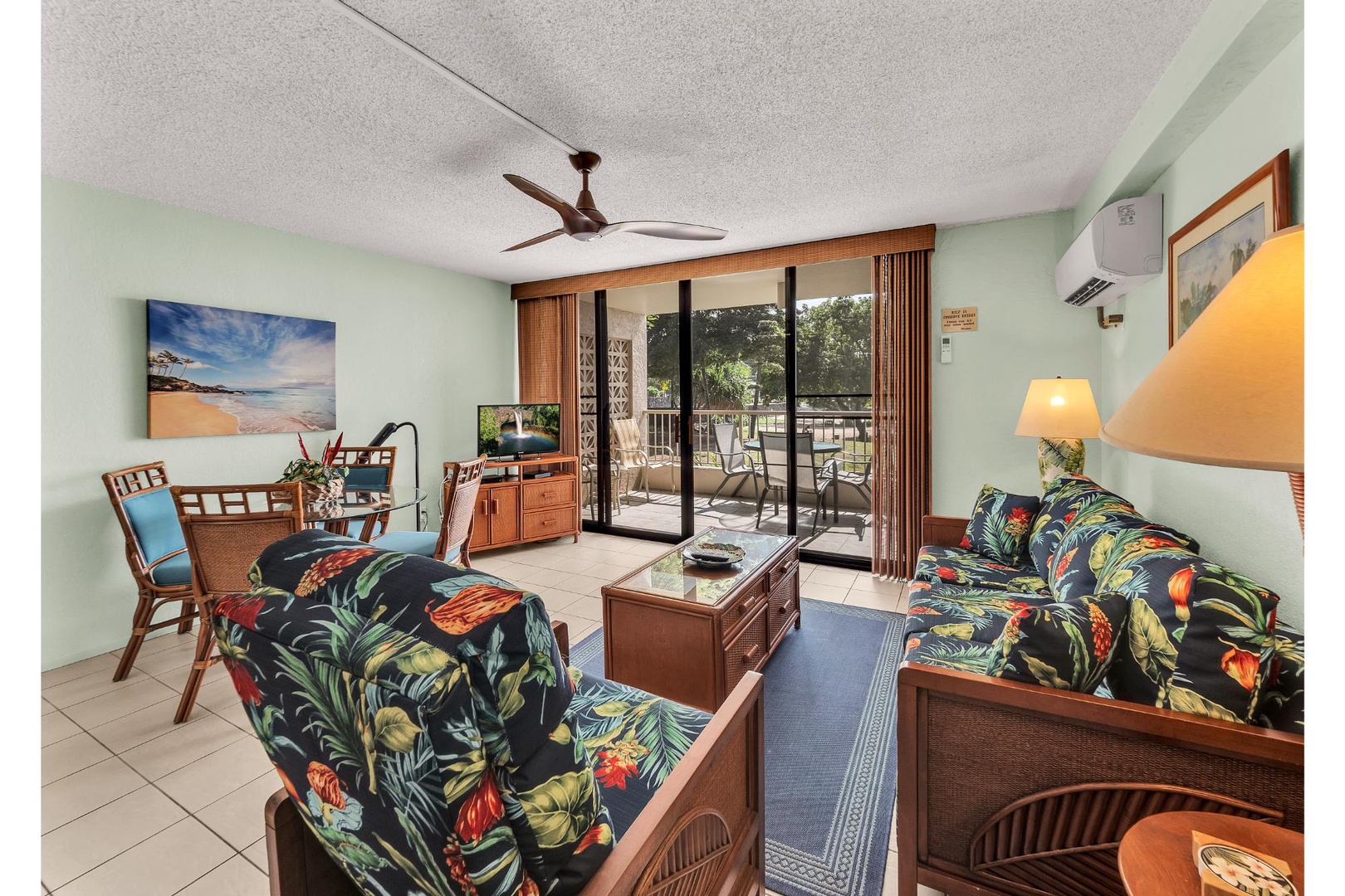 Relax in your bright tropical living room where vibrant floral seating and warm wood tones create a cheerful island atmosphere. Step out to your private balcony for morning coffee.