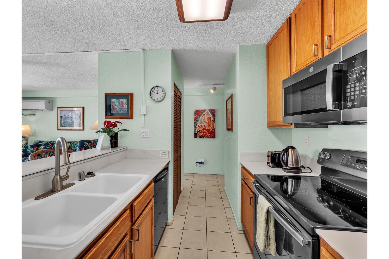 Cook your favorite meals in this fully equipped kitchen with modern appliances, ample counter space, and warm wood cabinetry.