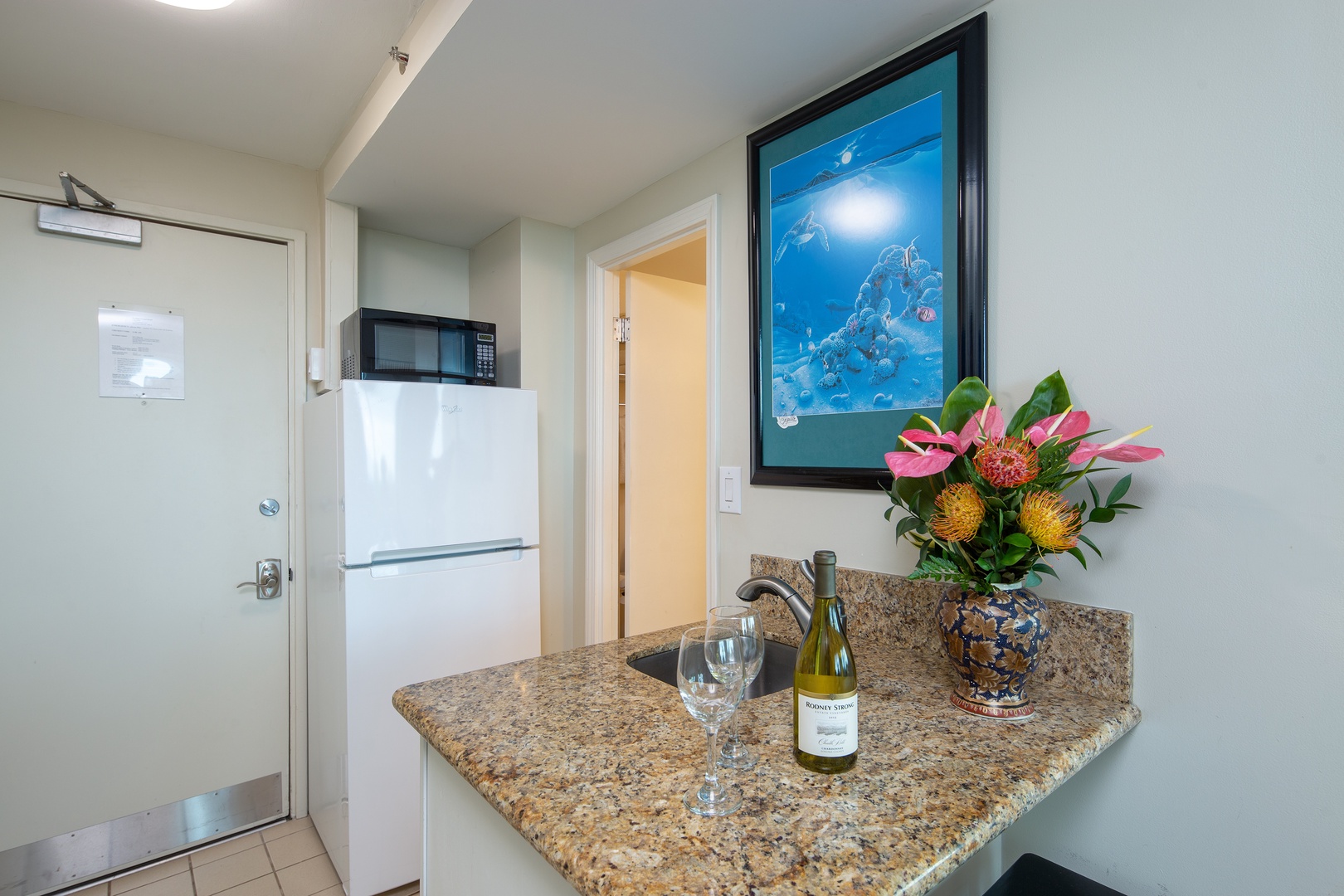 A warm welcome awaits in your private entrance, where island-inspired artwork and fresh tropical flowers set the tone for a relaxing Hawaiian escape.