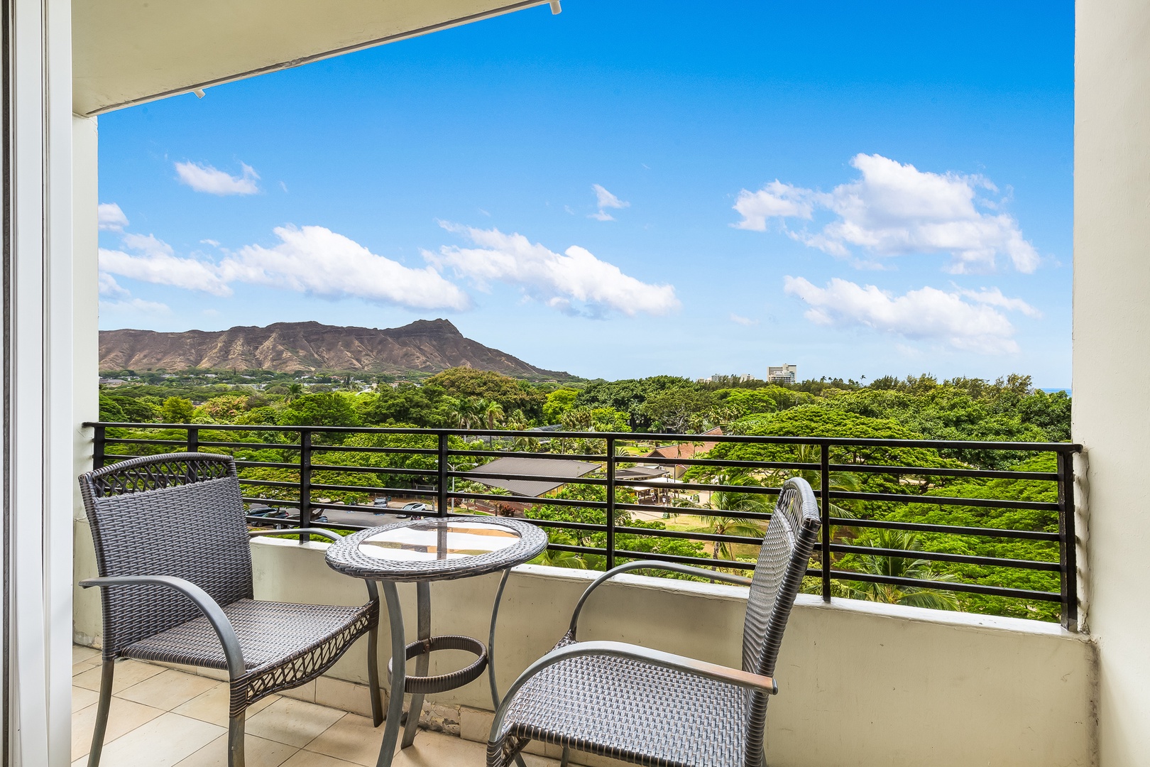 Sip your morning coffee while gazing at the iconic Diamond Head crater framed by lush tropical greenery from your private balcony.