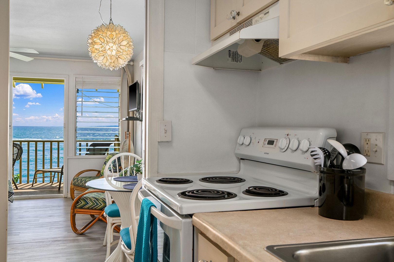 Cook your favorite meals while enjoying stunning ocean views from this bright kitchen with modern appliances and tropical charm.