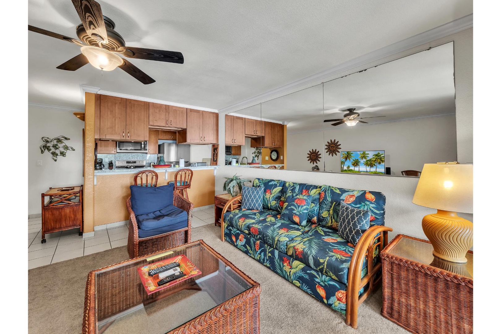 Your tropical-themed living space seamlessly flows into a fully equipped kitchen, creating the perfect setting for relaxing vacation moments.