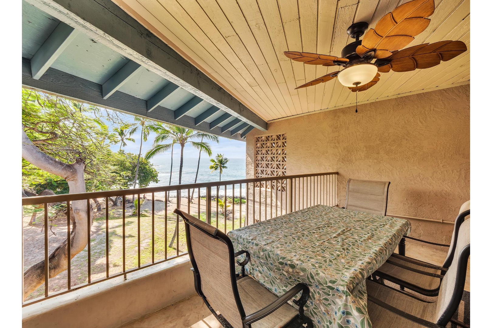 Dine al fresco on your private covered balcony with stunning tropical views and gentle breezes from the ceiling fan above.