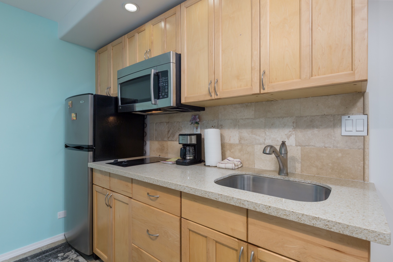 Your well-equipped kitchenette features modern appliances and ample counter space for preparing light meals during your stay.