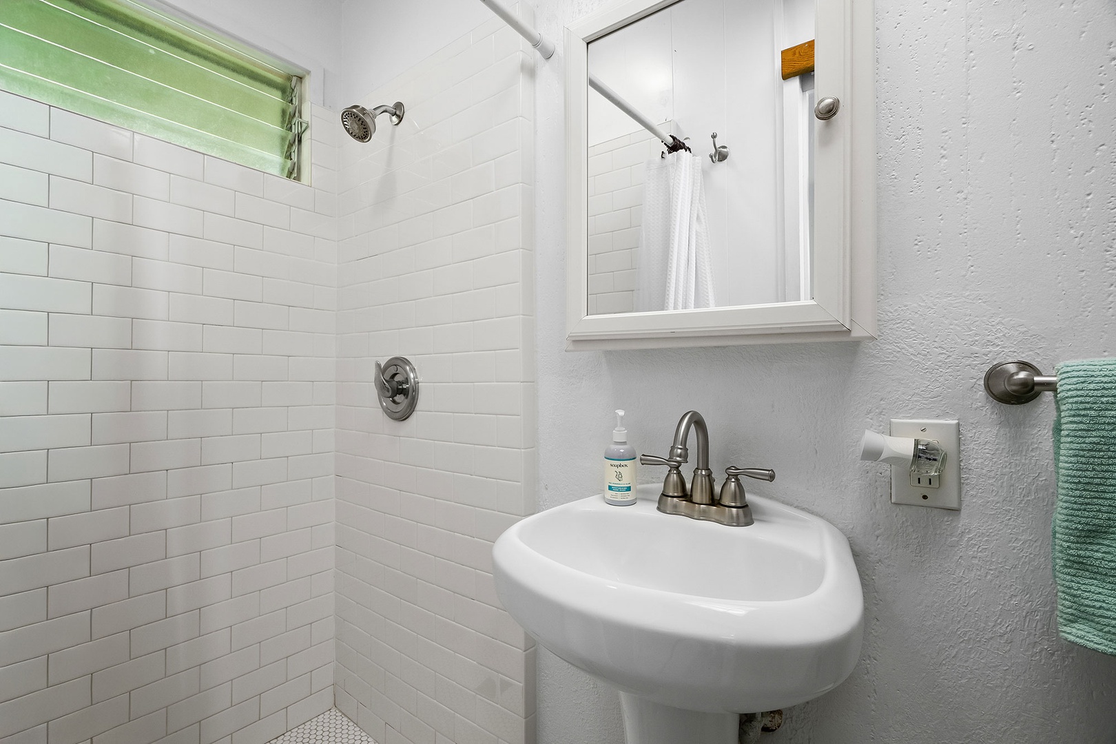 Step into your bright bathroom featuring classic subway tile and modern fixtures for a refreshing start to each day.