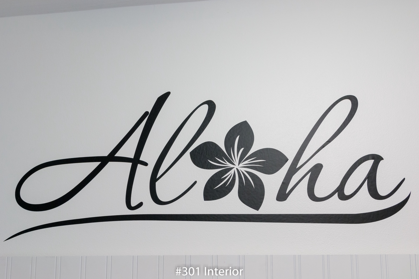 The welcoming 'Aloha' greeting adorns the wall, setting a warm, island-inspired tone that invites you to relax and embrace your tropical getaway.