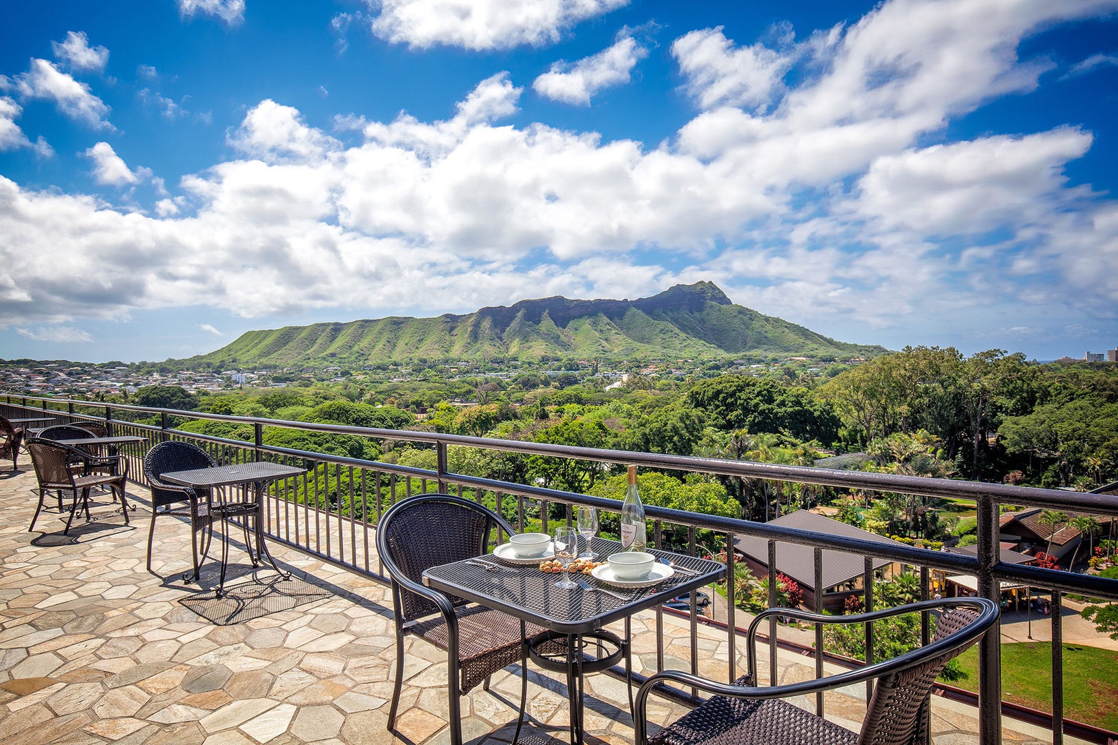 Stunning rooftop terrace overlooking iconic Diamond Head crater, lush greenery, and distant ocean—a scenic backdrop framing the property's prime Honolulu location, perfect for taking in the island's beauty.