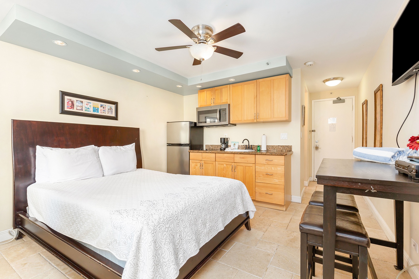 Unwind in your comfortable studio with a plush bed, full kitchenette, dining area, and ceiling fan to keep you cool. Everything you need for a relaxing getaway.