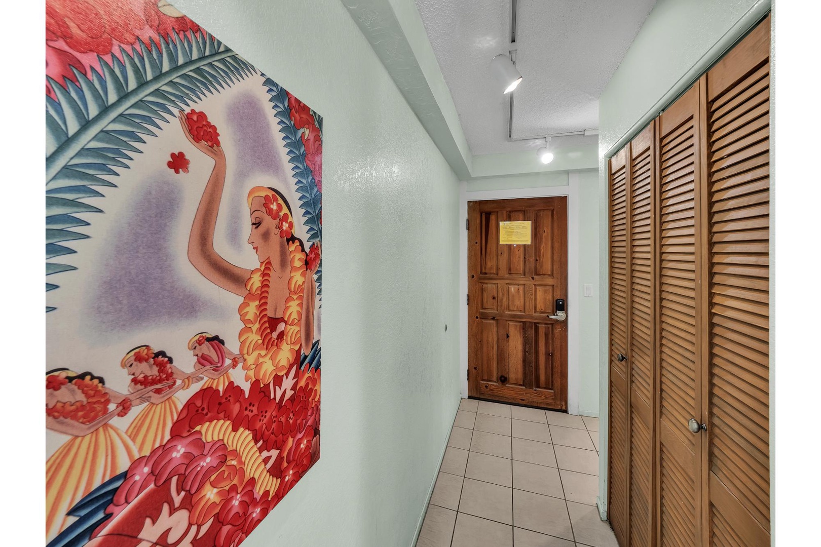 Step into your tropical paradise through this vibrant hallway featuring stunning Hawaiian-inspired artwork and warm wood accents that set the perfect island mood.