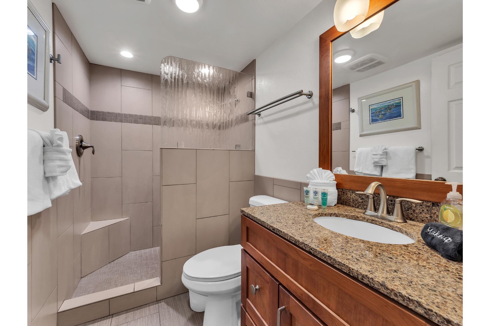 Indulge in your private spa-like bathroom with luxurious rainfall shower, granite counters, and premium amenities awaiting your arrival.
