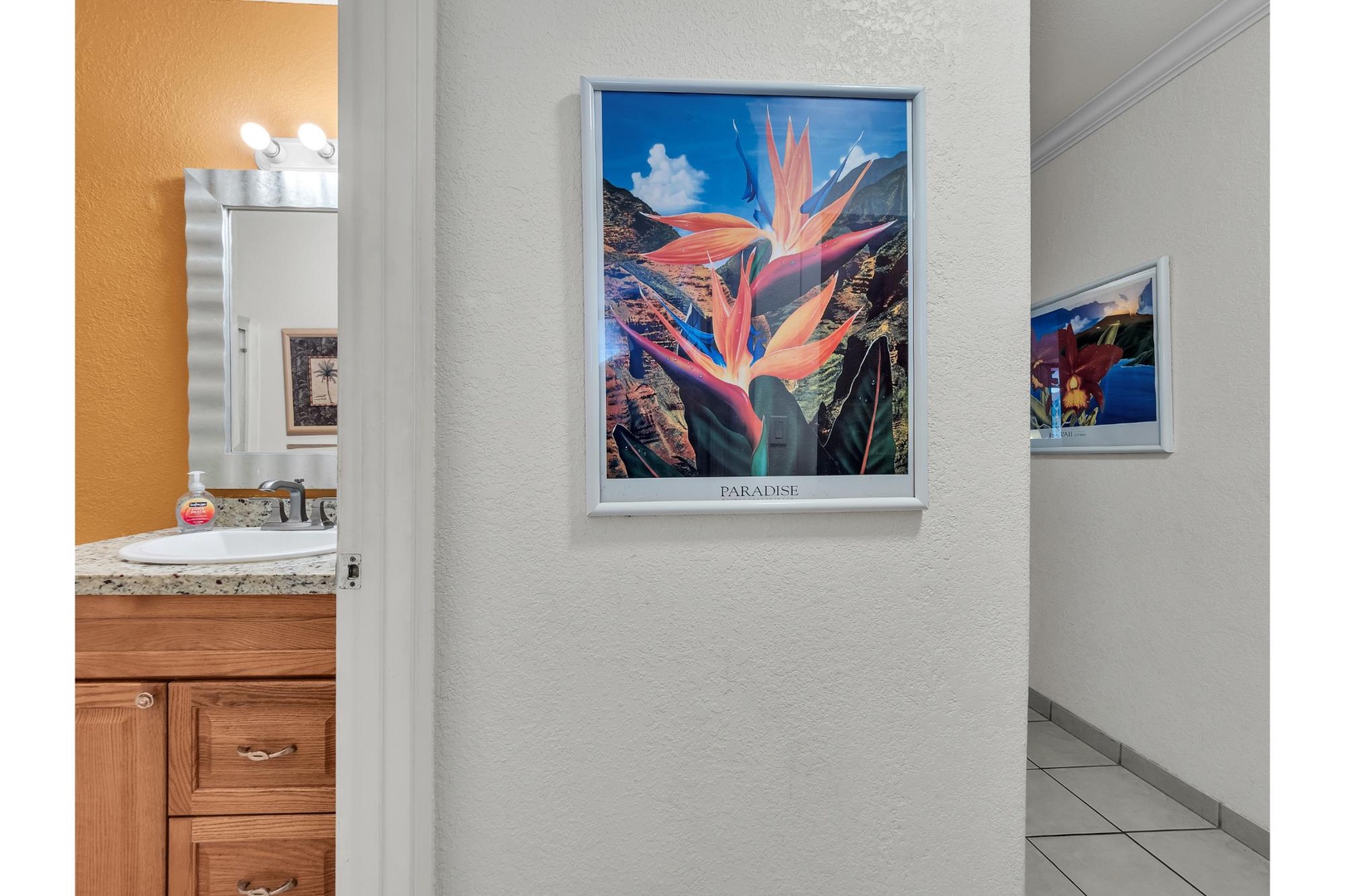 Your hallway welcomes you with tropical artwork, connecting your suite's comfortable spaces with warm, island-inspired charm throughout your stay.