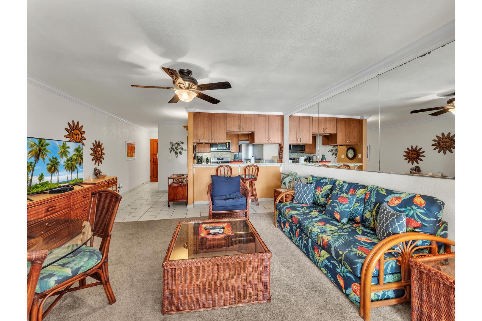 Unwind in this tropical-themed living space with vibrant Hawaiian furniture, open kitchen, and island-inspired décor that instantly transports you to paradise.