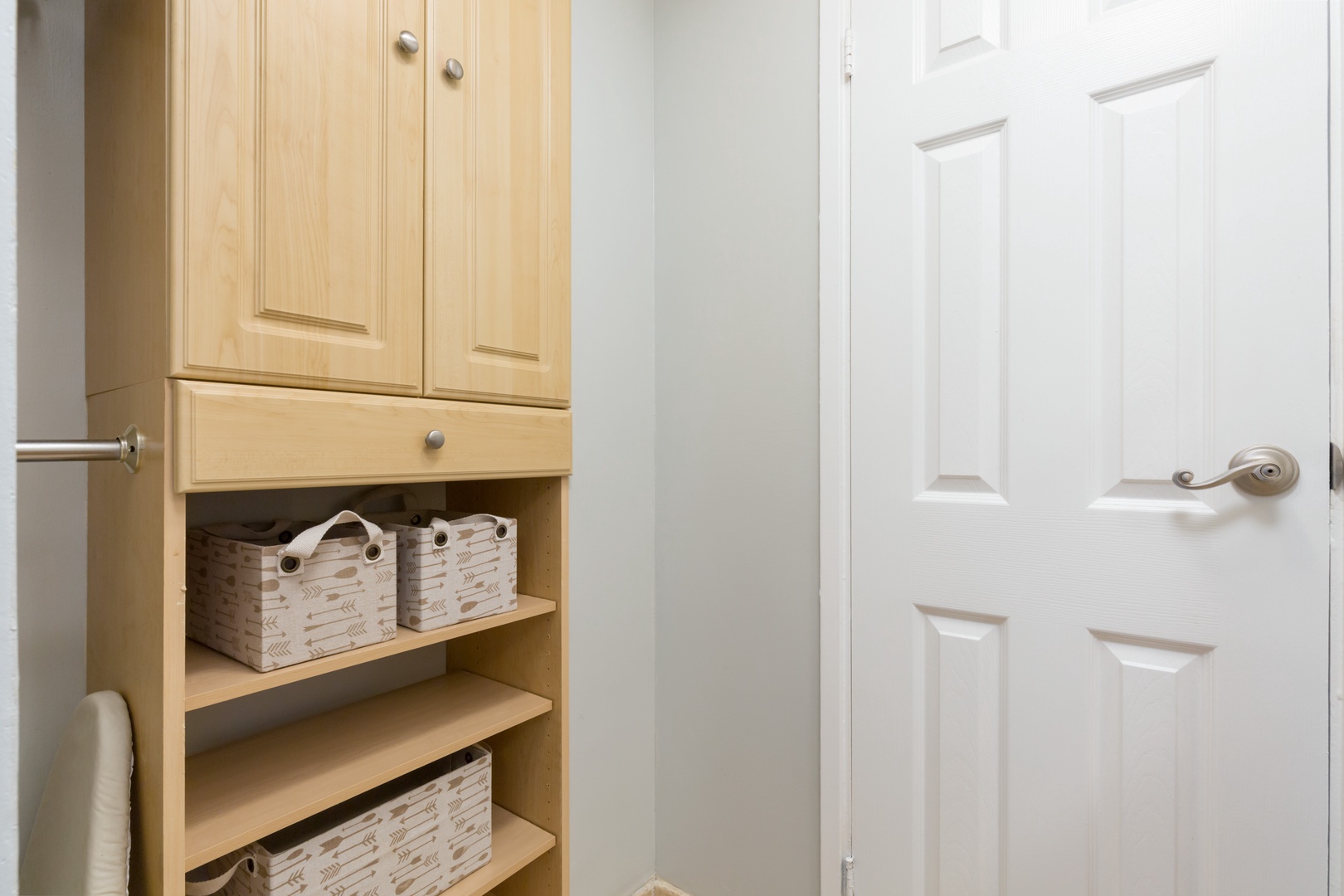 Light wood cabinetry with woven storage baskets keeps your essentials neatly tucked away, adding both function and coastal charm to your space.