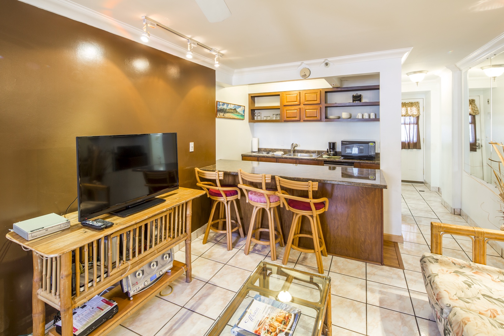 Picture yourself unwinding after a day of adventure in this cozy living space with a full kitchenette, perfect for casual meals or morning coffee at your breakfast bar.