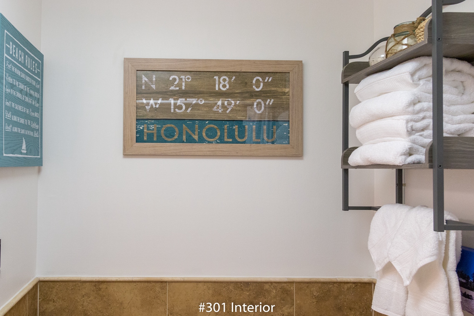 Fresh towels are ready for you in this welcoming bathroom space with beach-themed décor that celebrates the island spirit.
