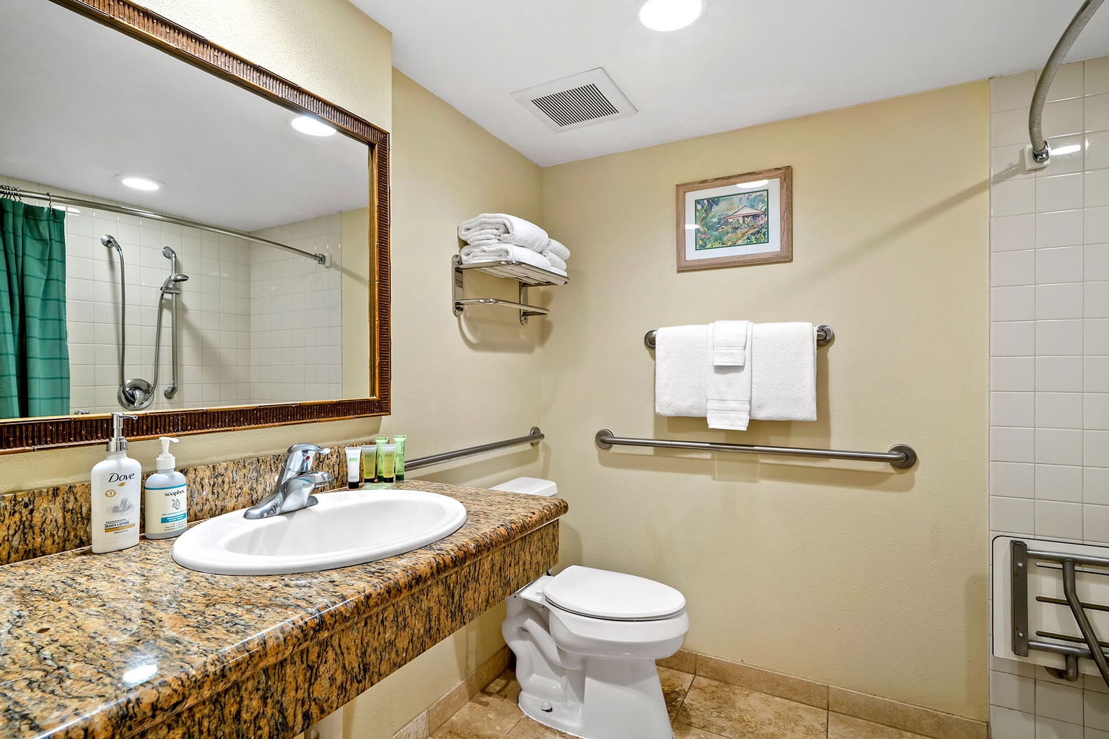 Step into your well-appointed bathroom featuring granite countertops, fresh towels, and accessibility features for your comfort.